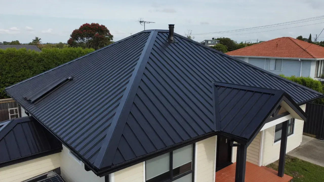 Freshly painted dark metal roof on a Hamilton suburban home after professional roof painting