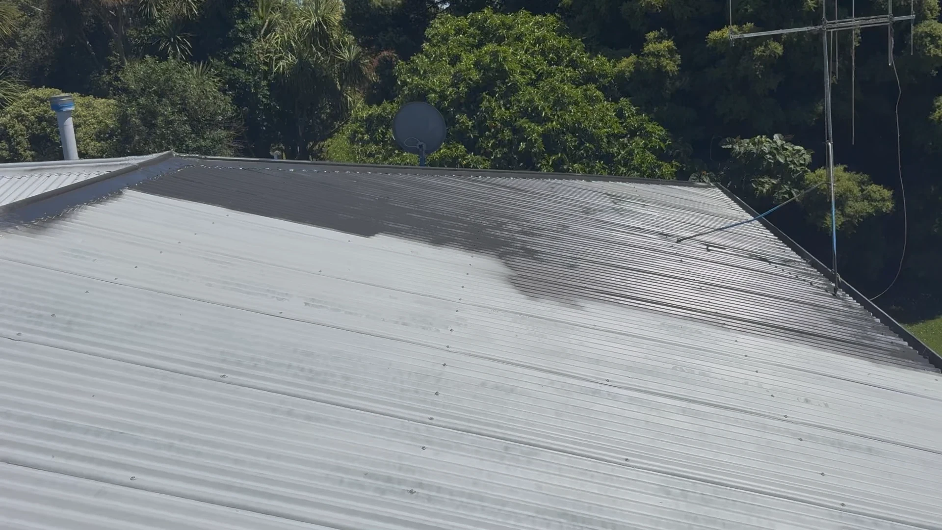 Repair process showing half-painted grey roof