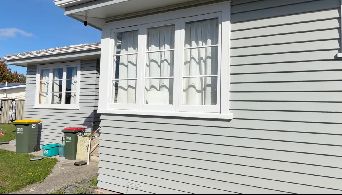 Finished Hamilton weatherboard exterior with crisp white window frames after Wattyl Solagard painting
