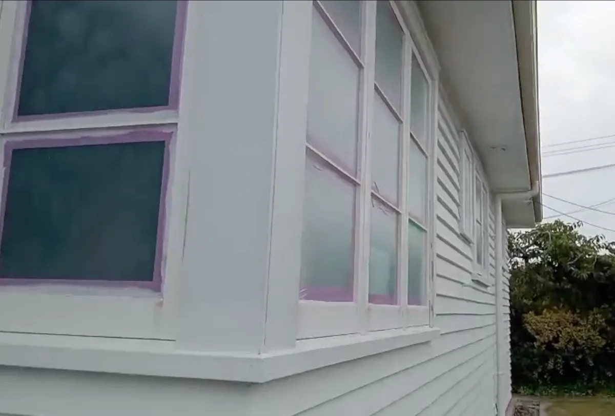 Liquid masking protecting Hamilton home windows before airless exterior painting
