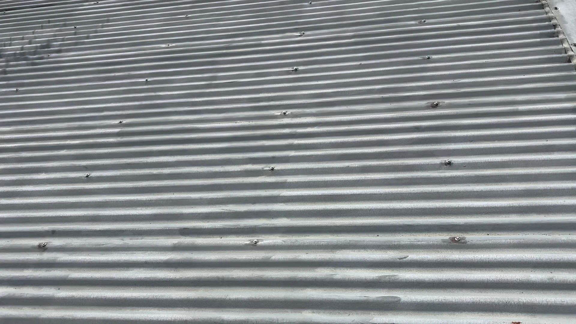 Close up of rusted roof screws before treatment